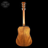 Back view of a wooden acoustic guitar on a black background with 'Tone Shop' logo.