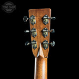 Close-up of a guitar headstock with tuning pegs on a black background, featuring the Tone Shop logo.