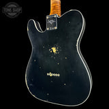 The back of a black electric guitar with a flamed maple neck, showing a vintage-style gold maple plate on the back, a gold tailpiece, and white binding against a black background.