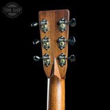 Close-up of a guitar headstock with tuning pegs on a black background, featuring 'Tone Shop' branding.