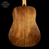 Back view of a wooden acoustic guitar with 'Tone Shop' logo in the corner.