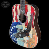 Acoustic guitar with American flag and eagle design on a black background