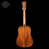 Back view of a wooden acoustic guitar with 'Tone Shop' logo in the corner.