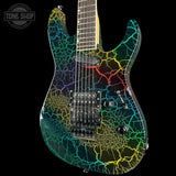 An electric guitar with a black base and a vibrant, multicolor crackle pattern in yellow, green, blue, and purple, shown against a solid black background with a Tone Shop watermark in the top left corner.