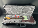 Electric guitar in a hard-shell case on a gray background