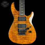 An electric guitar with a vibrant orange flame maple wood finish, shown from a front-facing angle against a solid black background. The brand logo on the headstock is not visible, and there is a 'TONE SHOP' watermark in the top left corner.