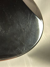 Close-up of a metallic surface with scratches and reflections
