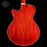 Close-up of the back of an electric guitar with a glossy red cherry wood finish and white binding, shown against a black background with a Tone Shop watermark in the upper left.