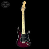 Electric guitar with a red and black body on a black background, featuring the Tone Shop logo.