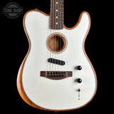 A white electric-acoustic guitar with a natural wood body and dark brown neck, shown against a solid black background. A Tone Shop watermark is visible in the top-left corner.