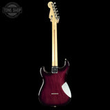 Electric guitar with a maroon body and light wood neck on a black background, featuring 'Tone Shop' branding.