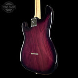 Electric guitar with a maroon finish on a black background, featuring the Tone Shop logo.