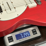 Used 2025 Collings 71M Fiesta Red on scale displaying weight.