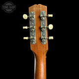 Close-up of the headstock of a wooden acoustic guitar against a black background, showing the brand name 'SUNRISE' and six tuning pegs with cream-colored knobs.