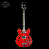 Red electric guitar on a black background with 'Tone Shop' logo.