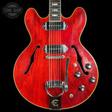 Red electric guitar with a black background
