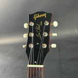 Gibson Les Paul guitar headstock on a dark background