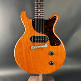 Electric guitar with a sunburst finish on a gray background