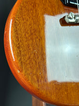 Close-up of a wooden surface with a metal screw and clear plastic sheet.