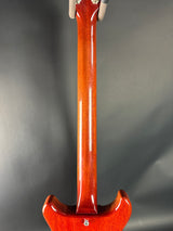 Close-up of a guitar's back on a gray background