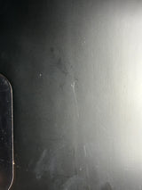 Scratched black surface with visible wear and tear