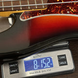 Used 2008 Fender American Vintage '62 Precision Bass Sunburst on scale displaying weight.