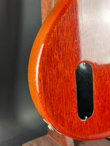 Close-up of a wooden guitar body with a dark pickguard.