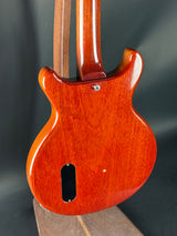 Close-up of a wooden guitar body on a dark background