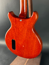 Close-up of a wooden electric guitar body on a dark background