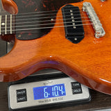 Electric guitar on a digital scale displaying weight