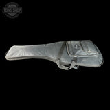 Gray guitar case with a visible brand logo on a black background