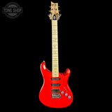 Red electric guitar with a black background