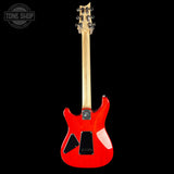 Red electric guitar with a black background, featuring the Tone Shop logo.