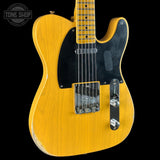 A yellow-finish Fender Telecaster electric guitar with a black pickguard and chrome hardware, shown against a black background with a Tone Shop watermark in the top left corner.