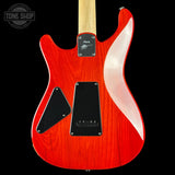 Red electric guitar with a white pickguard on a black background, featuring the Tone Shop logo.