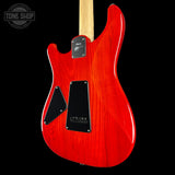 Red electric guitar with a black pickguard on a black background, featuring 'Tone Shop' branding.