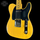 A classic Fender Telecaster electric guitar with a distressed yellow finish, black pickguard, and chrome hardware, shown against a solid black background with a Tone Shop watermark in the top left corner.