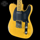 A classic Fender Telecaster electric guitar with a yellow sunburst finish, black pickguard, and chrome hardware, shown against a solid black background with a Tone Shop watermark in the top left corner.