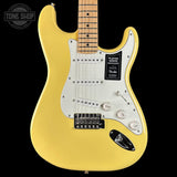 Yellow electric guitar with a visible Fender logo on a black background