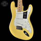 Yellow electric guitar with a visible Fender logo on a black background