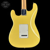 Yellow electric guitar with a visible brand logo on a black background