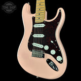 Beige electric guitar with a black pickguard on a black background, featuring 'Tone Shop' branding.