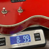 Gretsch USA Custom Shop 1959 Penguin Relic Western Red on scale displaying weight.
