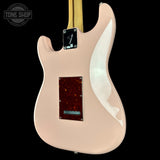 Guitar body with a flame maple top on a black background, featuring the Tone Shop logo.