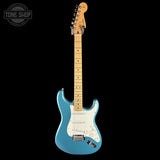 Blue electric guitar with a white pickguard on a black background, featuring 'Tone Shop' logo.