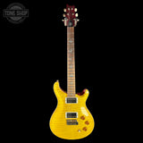 A yellow flamed maple electric guitar with a dark reddish-brown headstock, shown against a solid black background. A 'TONE SHOP' watermark is visible in the top-left corner.