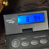 Vintage 1978 Gibson Explorer Natural on scale displaying weight.