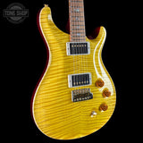 A yellow flamed maple electric guitar with a dark red body edge, shown against a black background. A Tone Shop watermark is visible in the top-left corner.
