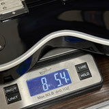 A close-up of a digital scale displaying 8.54 lbs (38.