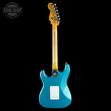 A turquoise blue electric guitar shown from the back against a solid black background, with a maple neck and a Tone Shop watermark in the upper left corner.